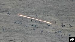 In this image taken from YouTube footage released by Armenian Defense Ministry Sept. 13, 2022, shows Azerbaijani servicemen crossing the Armenian-Azerbaijani border and approaching Armenian positions.