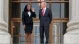 Justice Ketanji Brown Jackson, left, is escorted by Chief Justice of the United States John Roberts following her formal investiture ceremony at the Supreme Court in Washington, Sept. 30, 2022.