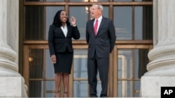 Justice Ketanji Brown Jackson, left, is escorted by Chief Justice of the United States John Roberts following her formal investiture ceremony at the Supreme Court in Washington, Sept. 30, 2022.
