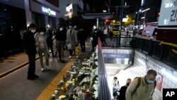 Flowers are displayed to pay tribute for victims near the scene of a deadly accident in Seoul, Oct. 30, 2022, following Saturday night's Halloween festivities.
