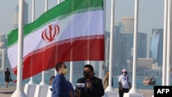 FILE - The Iranian flag is pictured before being raised among those of qualifying nations, along the Doha Corniche in front of the countdown clock on Feb. 3, 2022, as Qatar prepares to host the FIFA World Cup 2022.