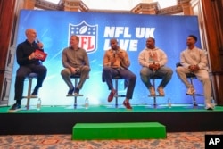 NFL Commissioner Roger Goodell, second left, Osi Umenyiora, third left, Maurice Jones-Drew, second right, and Victor Cruz, right, at Intl. Series Fan Forum, London, Oct. 8, 2022.