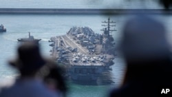 FILE - The nuclear-powered aircraft carrier USS Ronald Reagan is escorted as it arrives in Busan, South Korea, Sept. 23, 2022.