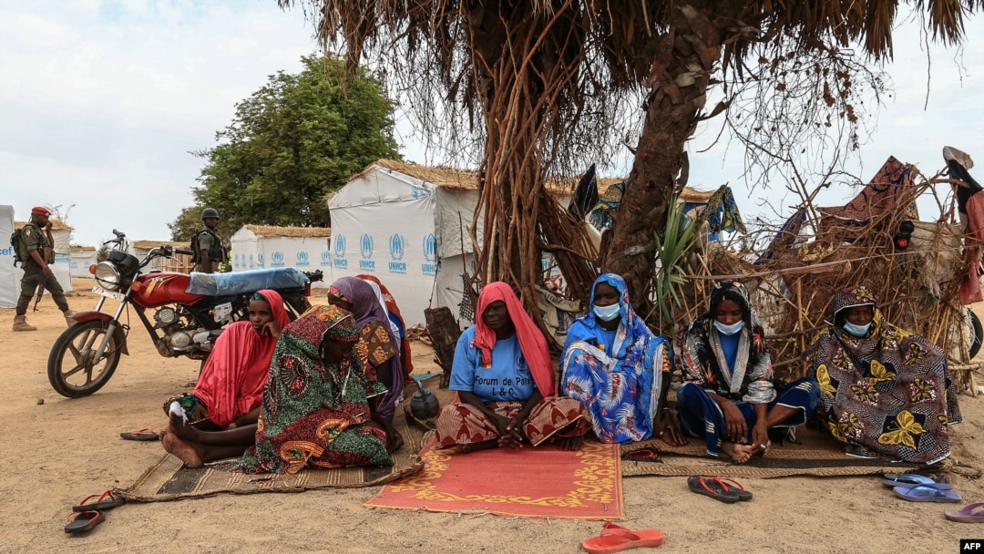 FILE - A group of women take shelter under a tree at the Bogo Internally Displaced Persons camp in Maroua, Cameroon, April 28, 2022.