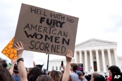 FILE - People protest at the Supreme Court following the high court's decision to overturn Roe v. Wade in Washington, June 24, 2022.