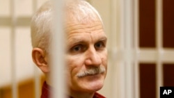 FILE - Ales Bialiatski, the head of Belarusian Vyasna rights group, stands in a defendants' cage during a court session in Minsk, Belarus, on Nov. 2, 2011. He was named one of three recipients of the 2022 Nobel Peace Prize on Oct. 7, 2022, and is in prison again.