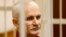 FILE - Ales Bialiatski, the head of Belarusian Vyasna rights group, stands in a defendants' cage during a court session in Minsk, Belarus, on Nov. 2, 2011. He was named one of three recipients of the 2022 Nobel Peace Prize on Oct. 7, 2022, and is in prison again.