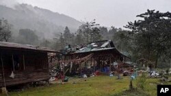 Debris from air strikes scatters about destroyed wooden structures near Aung Bar Lay Village, Hpakant township, Kachin state in Myanmar on October 24, 2022. (Associated Press)