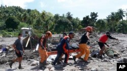Tim penyelamat membawa mayat korban tanah longsor di kota Datu Odin Sinsuat, Maguindanao, Filipina selatan, Minggu 30 Oktober 2022. (AP)