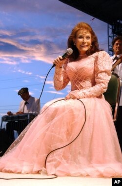 FILE - Loretta Lynn sings during a solo concert at the Washington County Fair in West Bend, Wis., July 22, 2004.