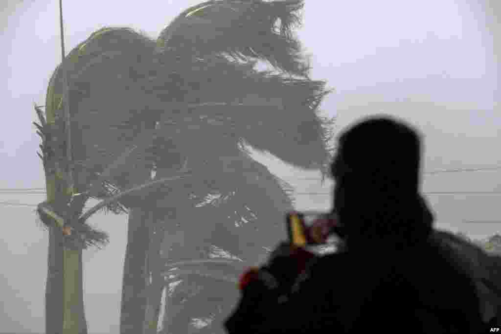 A man livestreams as gusts from Hurricane Ian hit Punta Gorda, Florida, on Sept. 28, 2022.