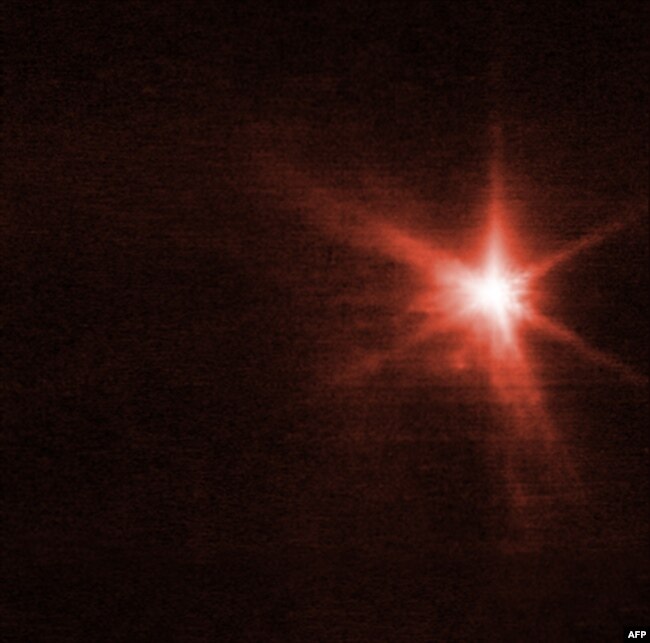 This handout picture released Sept. 29, 2022, by the European Space Agency is an image from the Webb telescope's Near-Infrared Camera showing Dimorphos, an asteroid moonlet, about four hours after NASA's Double Asteroid Redirection Test (DART) made impact.