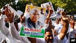 Congress Party supporters celebrate outside the residence of newly elected party president Mallikarjun Kharge in New Delhi, India, Oct. 19, 2022. 