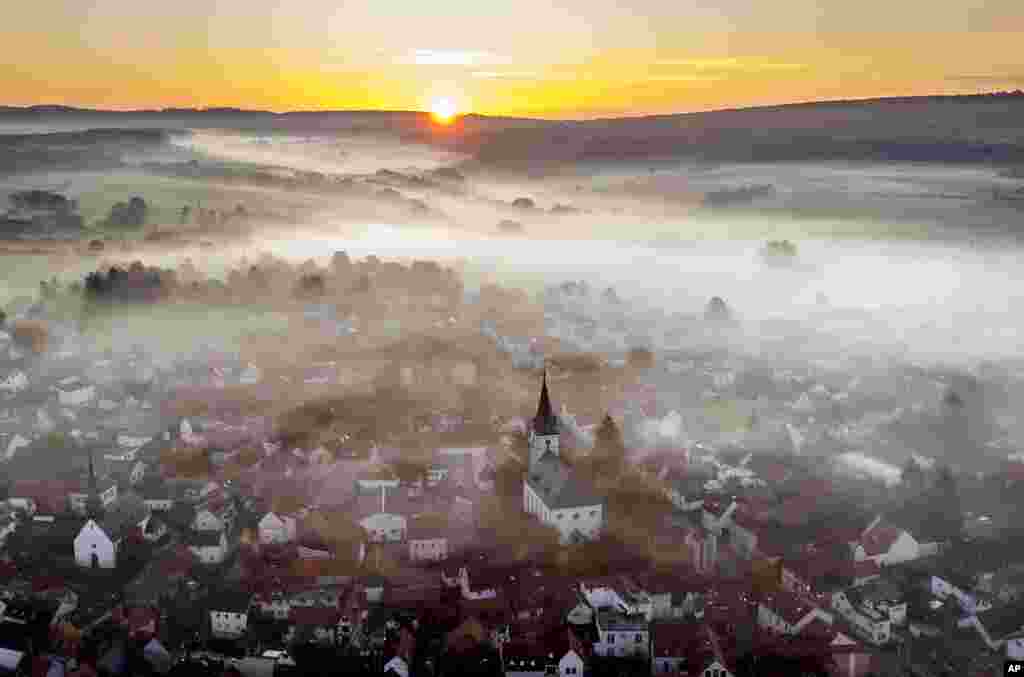 Fog lies over the city of Wehrheim near Frankfurt, Germany.