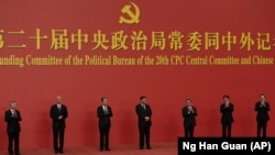 From left, Li Xi, Cai Qi, Zhao Leji, President Xi Jinping, Li Qiang, Wang Huning, and Ding Xuexiang are introduced at the Great Hall of the People in Beijing on Oct. 23, 2022. (AP Photo/Ng Han Guan, File)
