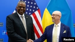 U.S. Secretary of Defense Lloyd Austin with Ukrainian Minister of Defense Oleksii Reznikov ahead of a meeting of the Ukraine Defense contact group in Brussels, Belgium, October 12, 2022. (Stephanie Lecoco/via Reuters)