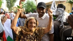 FILE: In an earlier anti-government demonstration against the military coup and a delayed return to civilian rule, Sudanese protesters pose for a picture in Omdourman the capital Khartoum's twin city on October 21, 2022. 