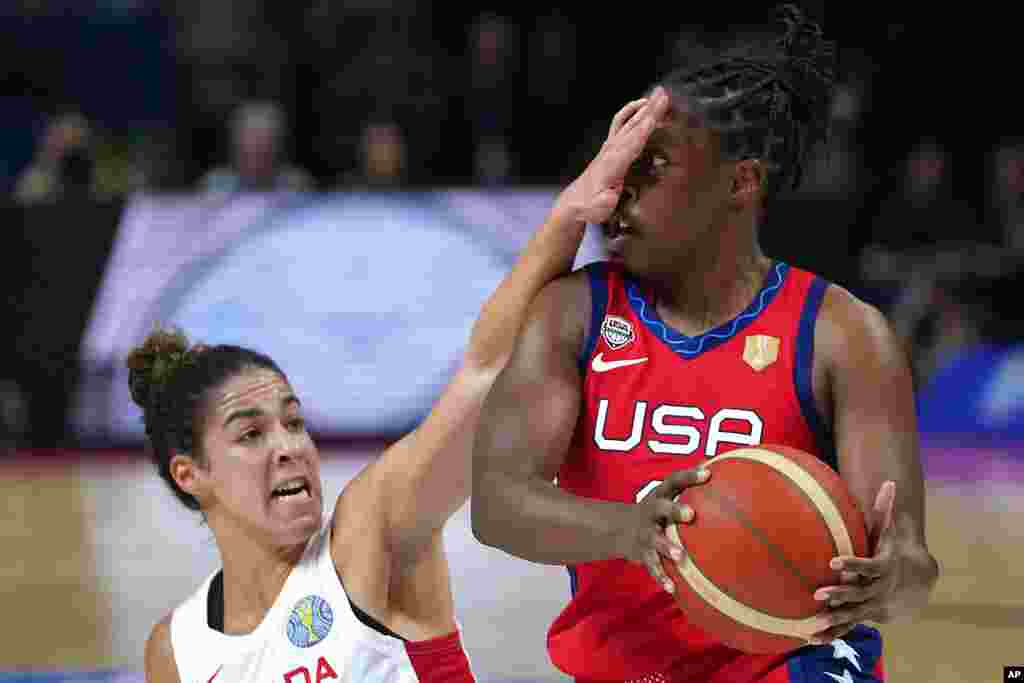 Canada's Kia Nurse, left, covers the face of United States' Chelsea Gray during their semifinal game at the women's Basketball World Cup in Sydney, Australia.