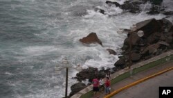 People relax at shore in Mazatlan, Mexico, Oct. 2, 2022. Hurricane Orlene, at Category 3 strength, is heading for a collision with Mexico's northwest Pacific coast between the tourist towns of Mazatlan and San Blas.