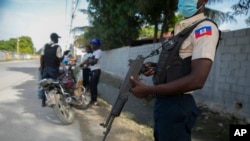 Police officers check motorcycle drivers in Port-au-Prince, Haiti, Oct. 15, 2022. 