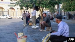 Iranian workers wait for jobs at Workers Square in front of the Great Mosque in central Sulaimaniyah in Iraq's autonomous Kurdistan region, Oct. 5, 2022.