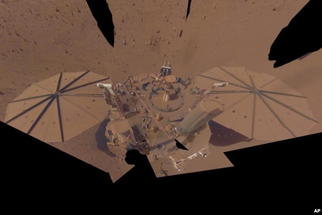 This image provided by NASA shows the InSight Mars lander in a selfie photo composite on April 24, 2022. The lander's solar panels have become covered with dust since the lander touched down on Mars in November 2018, which has led to a gradual decline in its power level. (NASA/JPL-Caltech via AP)