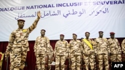 FILE - Chad transition leader Mahamat Idriss Deby (L) gestures during the opening ceremony of a national dialogue meeting at the January 15 Palace in N'Djamena, Aug. 20, 2022.