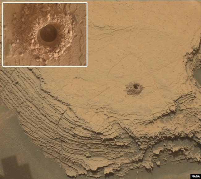 Curiosity used its Mast Camera, or Mastcam, to capture this image of its 36th successful drill hole on Mount Sharp, at a rock called “Canaima.” The rovers Mars Hand Lens Imager took the inset image. The pulverized rock sample was acquired on Oct. 3, 2022. (Credits: NASA/JPL-Caltech/MSSS)