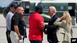 President Joe Biden shakes hands with Rep. Byron Donalds as he and first lady Jill Biden are greeted after arriving at Southwest Florida International Airport to visit areas impacted by Hurricane Ian, Oct. 5, 2022, in Fort Myers, Fla.