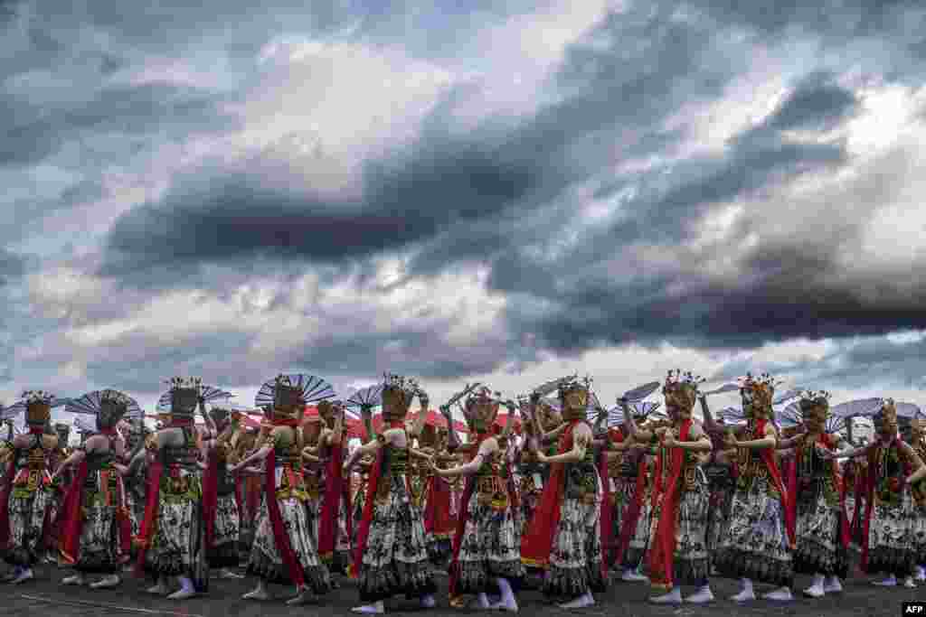 Traditional dancers perform during the annual Gandrung Sewu festival on Boom beach in Banyuwangi, Indonesia, Oct. 29, 2022.