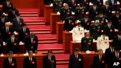 Attendees observe a moment of silence for fallen comrades during the opening ceremony of the 20th National Congress of China's ruling Communist Party held at the Great Hall of the People in Beijing, China, Oct. 16, 2022.