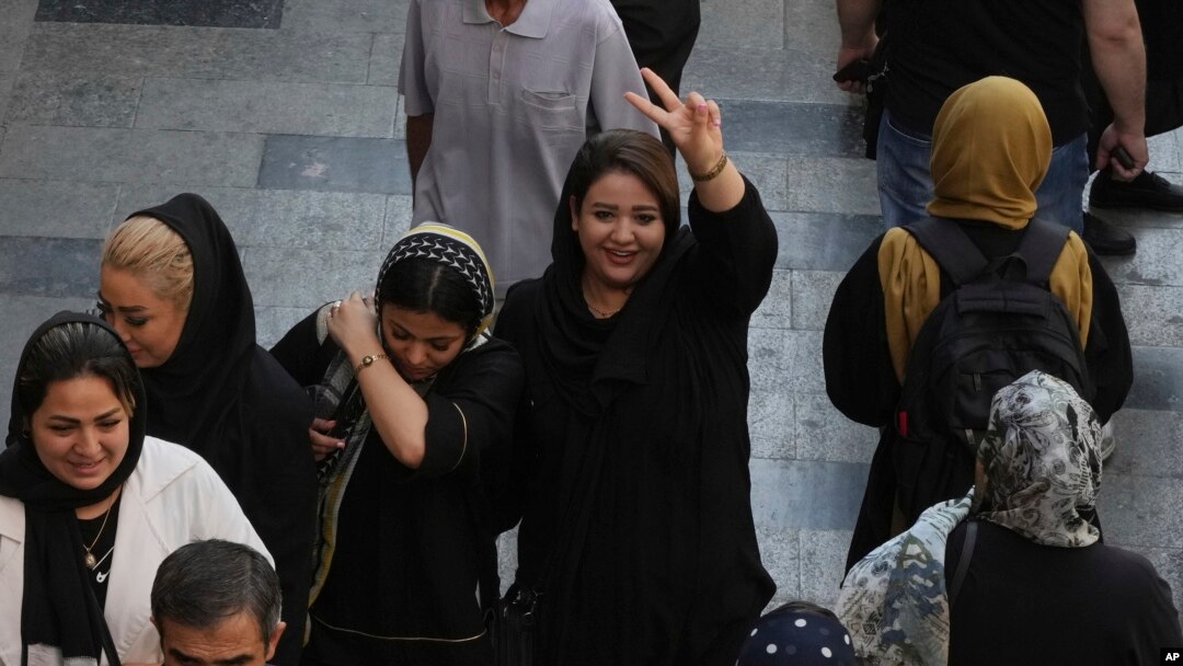 Seorang perempuan mengacungkan jari yang mengartikan tanda kemenangan saat berada di pasar utama tua Teheran, 1 Oktober 2022, sebagai ilustrasi. (Foto: AP)