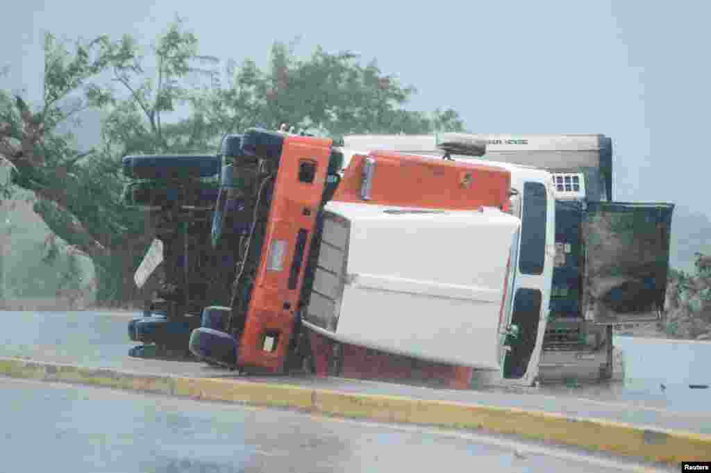 An overturned truck is seen on a highway following the passing of Hurricane Roslyn that hit the Mexico&#39;s Pacific coast with heavy winds and rain, in Tecuala in Nayarit state, Mexico.