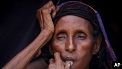 Hawo Adan, 71, who fled the area where she lived due to drought, sits in a camp for the displaced on the outskirts of Mogadishu, Somalia, Sept. 3, 2022. 