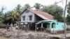 Residents prepare to leave their house at the former banana fields of the municipality of El Progreso, Honduras, before the arrival of Tropical Storm Julia, on Oct. 8, 2022.