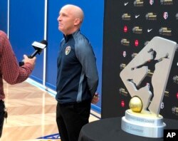 FILE - North Carolina Courage coach Paul Riley is interviewed next to the National Women's Soccer League championship trophy in Beaverton, Ore., Sept. 20, 2018. Former NWSL players alleged harassment and sexual coercion involving Riley dating back a decade.