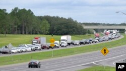 Eastbound traffic crowds Florida's Interstate 4 as people evacuate in preparation for Hurricane Ian approaches the western side of the state, Sept. 27, 2022, in Lake Alfred, Fla.