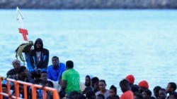 Beberapa migran menunggu untuk diturunkan dari perahu kayu di pelabuhan Arguineguin, di pulau Gran Canaria, Spanyol, 20 Oktober 2024. (Borja Suarez/REUTERS)