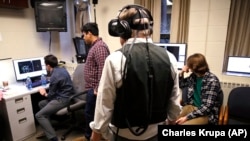 Students at Boston College in Boston, Massachusetts use one of their professors to test special technology for a video game they are developing.