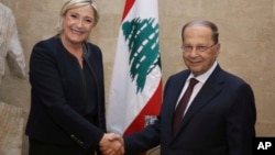 In this photo released by Lebanon's official government photographer Dalati Nohra, French far-right leader and presidential candidate Marine Le Pen, left, shakes hands with Lebanese President Michel Aoun, at the presidential palace, in Baabda, east Beirut, Lebanon, Feb. 20, 2017.