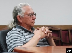 FILE - In this July 31, 2013 photo, O.J. Semans, of Rosebud, S.D., executive director of the voting advocacy group Four Directions, listens in Pierre, S.D., as the South Dakota Election Board discusses a proposal to use federal money to set up satellite v