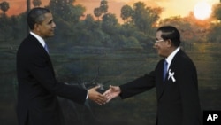 U.S. President Barack Obama, left, is greeted by Cambodia's Prime Minister Hun Sen before the ASEAN-U.S. leaders meeting in Phnom Penh, Cambodia, Monday, Nov. 19, 2012. (AP Photo/Vincent Thian)