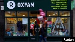 A pedestrian walks past a branch of Oxfam, in London, Feb. 12, 2018. 