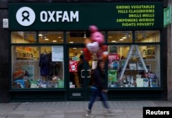 A pedestrian walks past a branch of Oxfam, in London, Feb. 12, 2018.