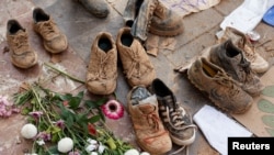 A view shows muddy shoes of volunteers who went to clean up in flood-affected areas as Spanish students attend a nation-wide protest against the emergency response and management of the deadly floods in eastern Spain, in Valencia, Nov. 12, 2024.