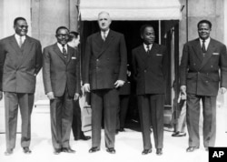 FILE - French President Charles de Gaulle of France poses with the four presidents of the states of the African Entente Council after a summit in Paris, France on March 7, 1961.