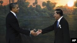 U.S. President Barack Obama, left, is greeted by Cambodia's Prime Minister Hun Sen before the ASEAN-U.S. leaders meeting in Phnom Penh, Cambodia, Monday, Nov. 19, 2012. (AP Photo/Vincent Thian)