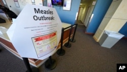 FILE - A measles sign is seen at the Texas Tech University Health Sciences Center in Lubbock, Texas, Feb. 25, 2025.