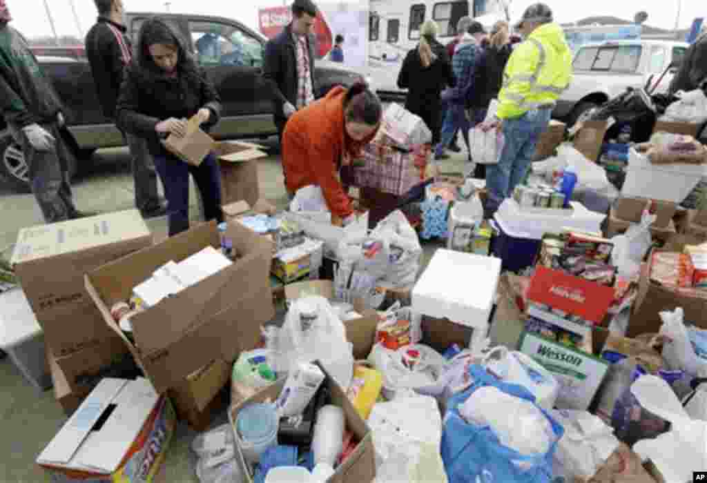 Volunteers collect food and personal care items for residents after a tornado in Henryville, Ind., Sunday, March 4, 2012.