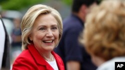 Democratic presidential candidate Hillary Clinton greets a spectator at a Fourth of July parade in Gorham, N.H., July 4, 2015.